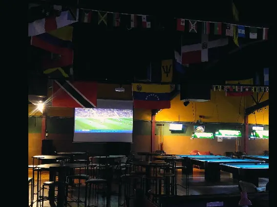 Football on the big screen above the pool tables at Monty's Legacy