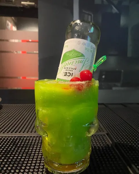 Apple Smash cocktail, green with a Smirnoff Apple bottle inserted
