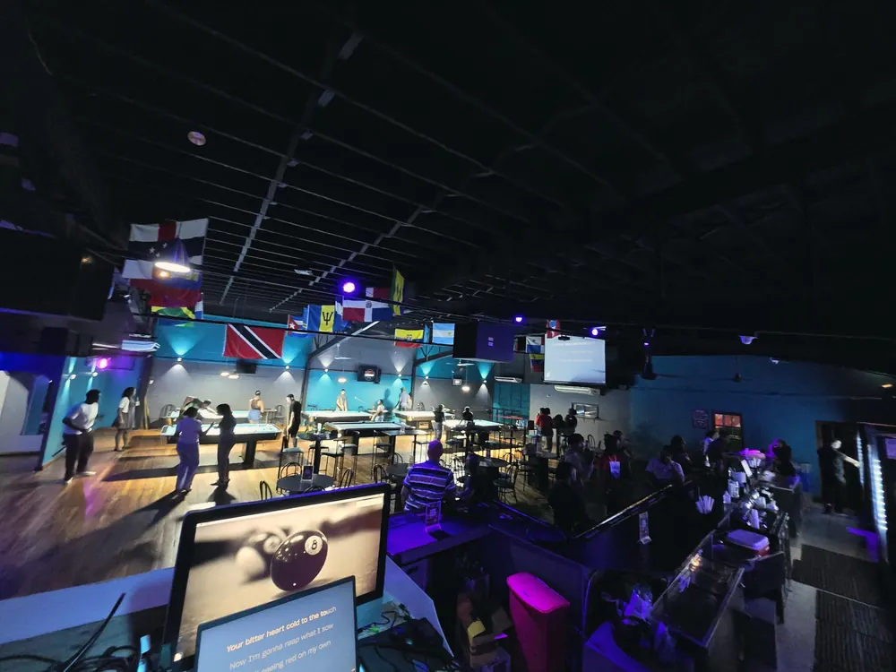 Six pool tables under the flags at Monty's Legacy, San Fernando